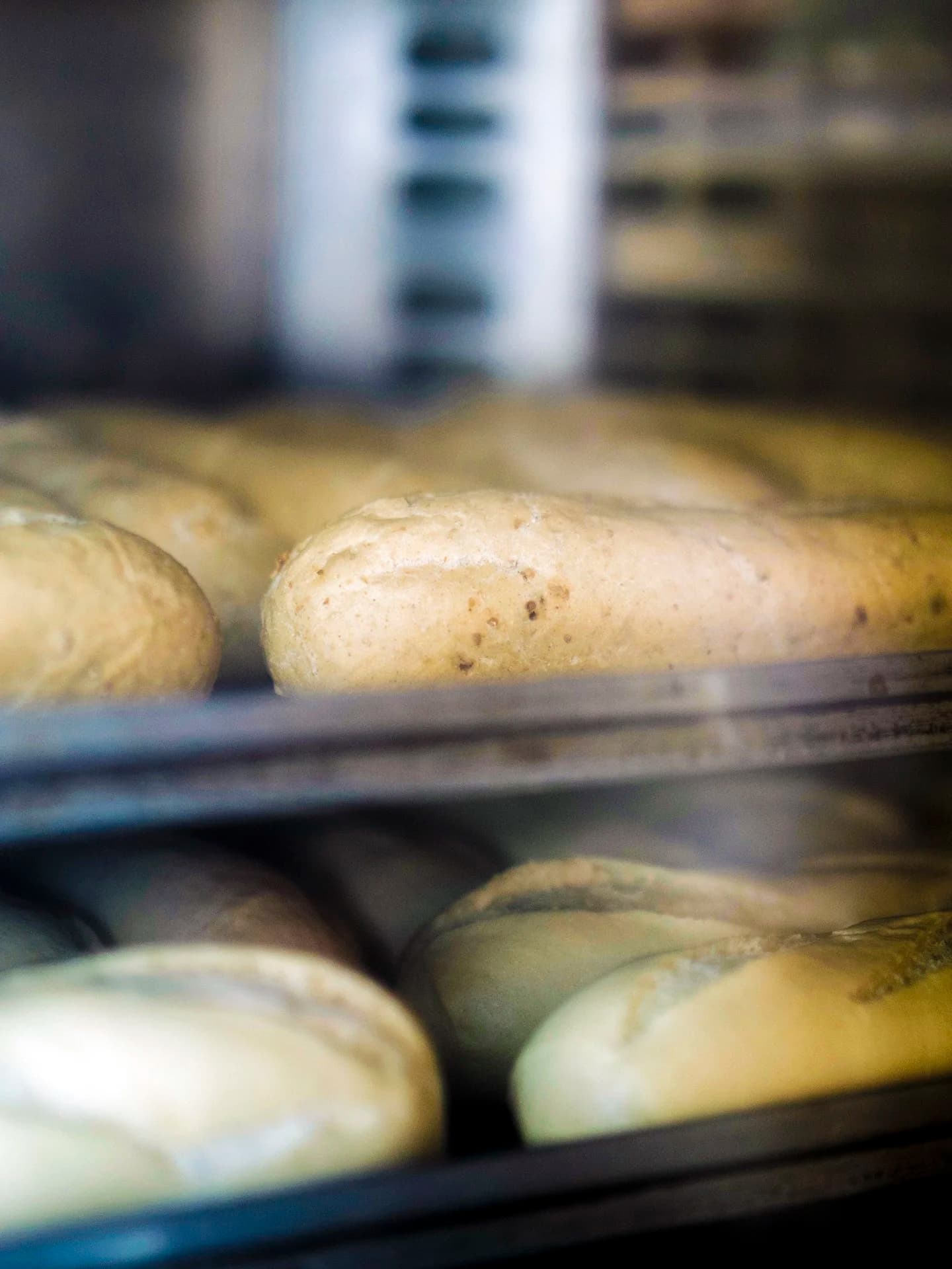 Savoury rolls and bakes baking behind the shop glass.